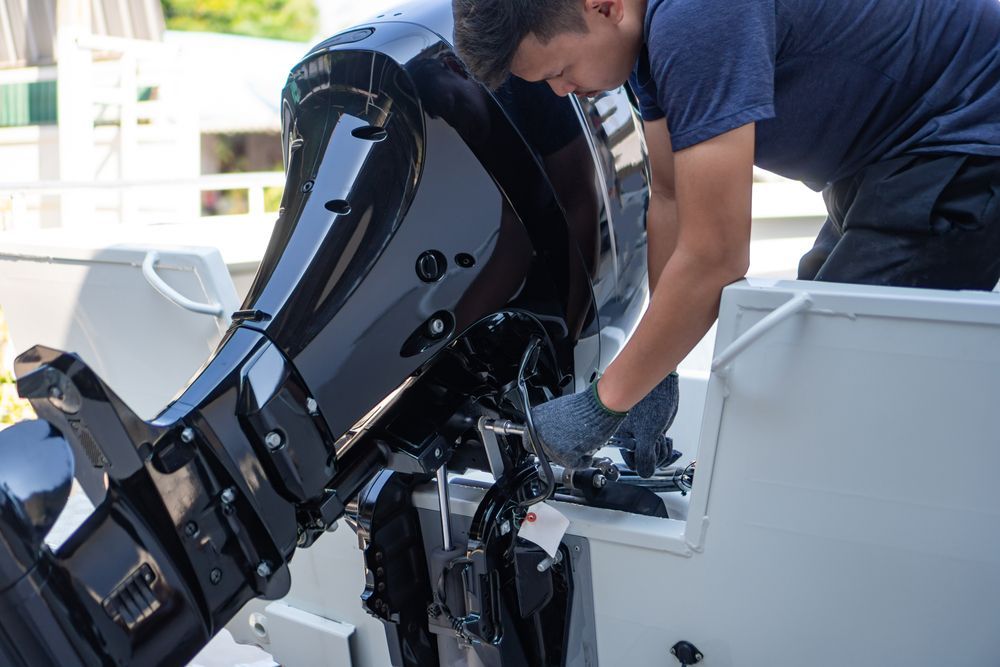 A Man Fixing A Black Shiny Outboard Motor — Mark's Outboards & More
In Kurri Kurri, NSW