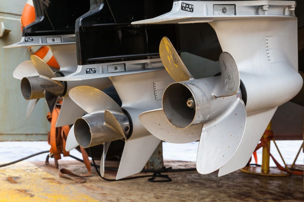 The Propellers Of A Boat Are Lined Up In A Row — Mark's Outboards & More In Kurri Kurri, NSW