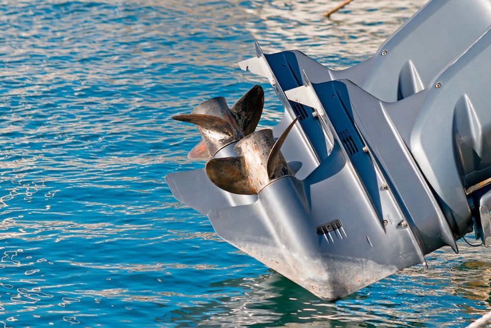 A Boat Engine Is Floating On Top Of A Body Of Water — Mark's Outboards & More In Lake macquarie, NSW