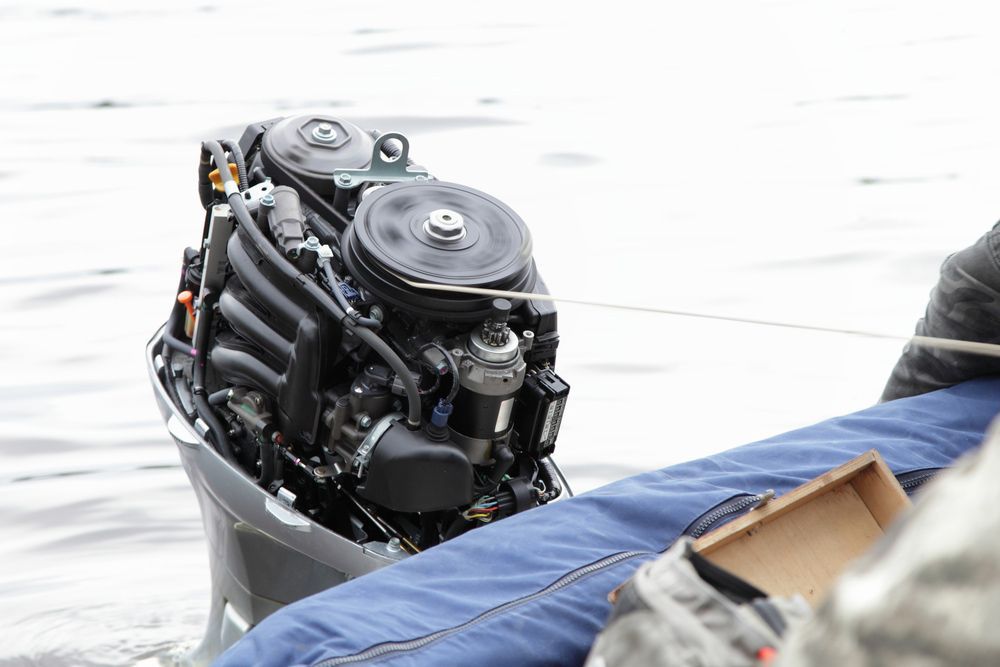 A Boat Engine Is Sitting On Top Of A Boat In The Water — Mark's Outboards & More In Cessnock, NSW