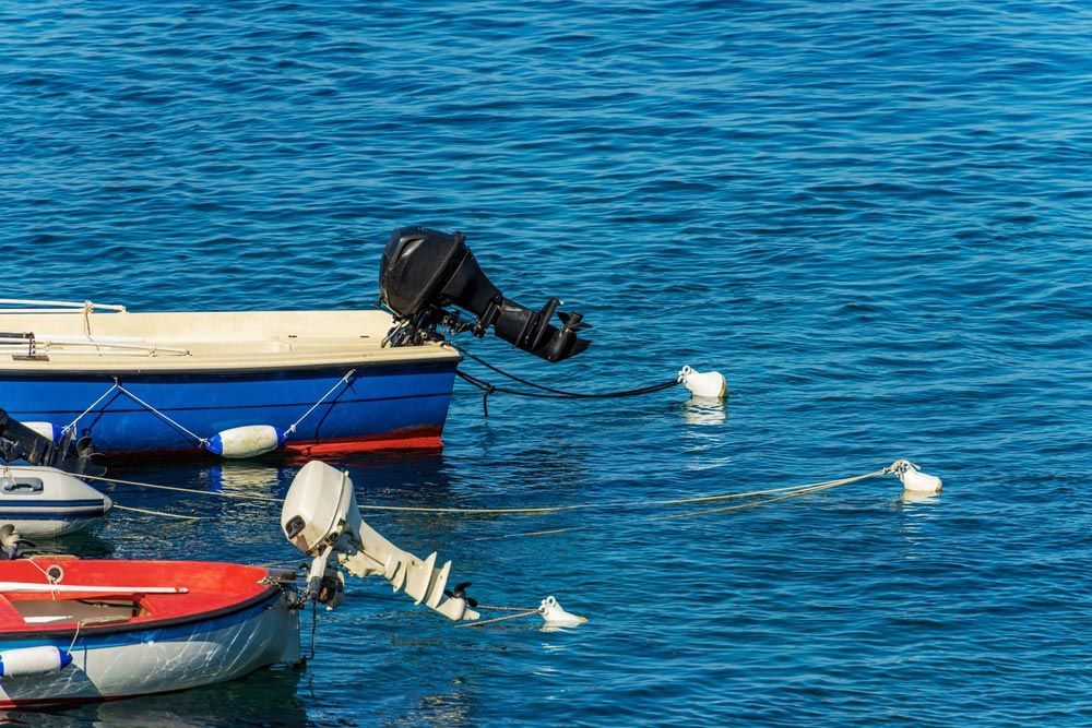 A Couple Of Boats Are Floating On Top Of A Body Of Water — Mark's Outboards & More In Port Stephens, NSW