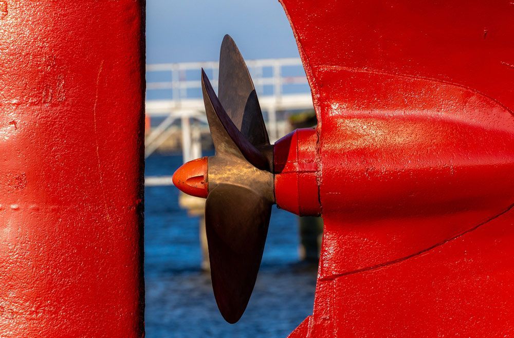 A Close Up Of A Propeller On A Red Boat — Mark's Outboards & More In Cessnock, NSW