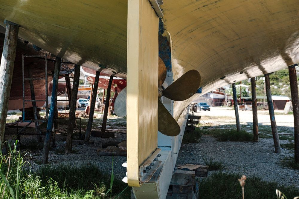 A Boat With A Propeller Attached To The Side Of It — Mark's Outboards & More In Cessnock, NSW
