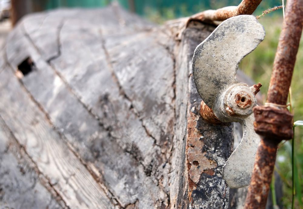 A Close Up Of A Rusty Propeller On A Wooden Boat — Mark's Outboards & More In Lake Macquarie, NSW