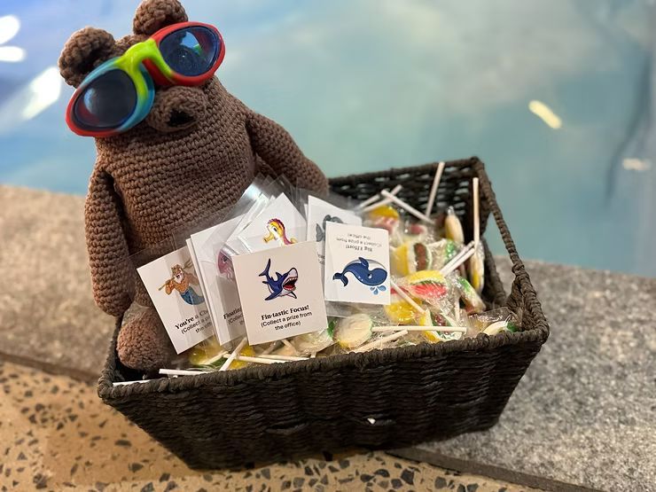 Albie holding stickers and lollipops