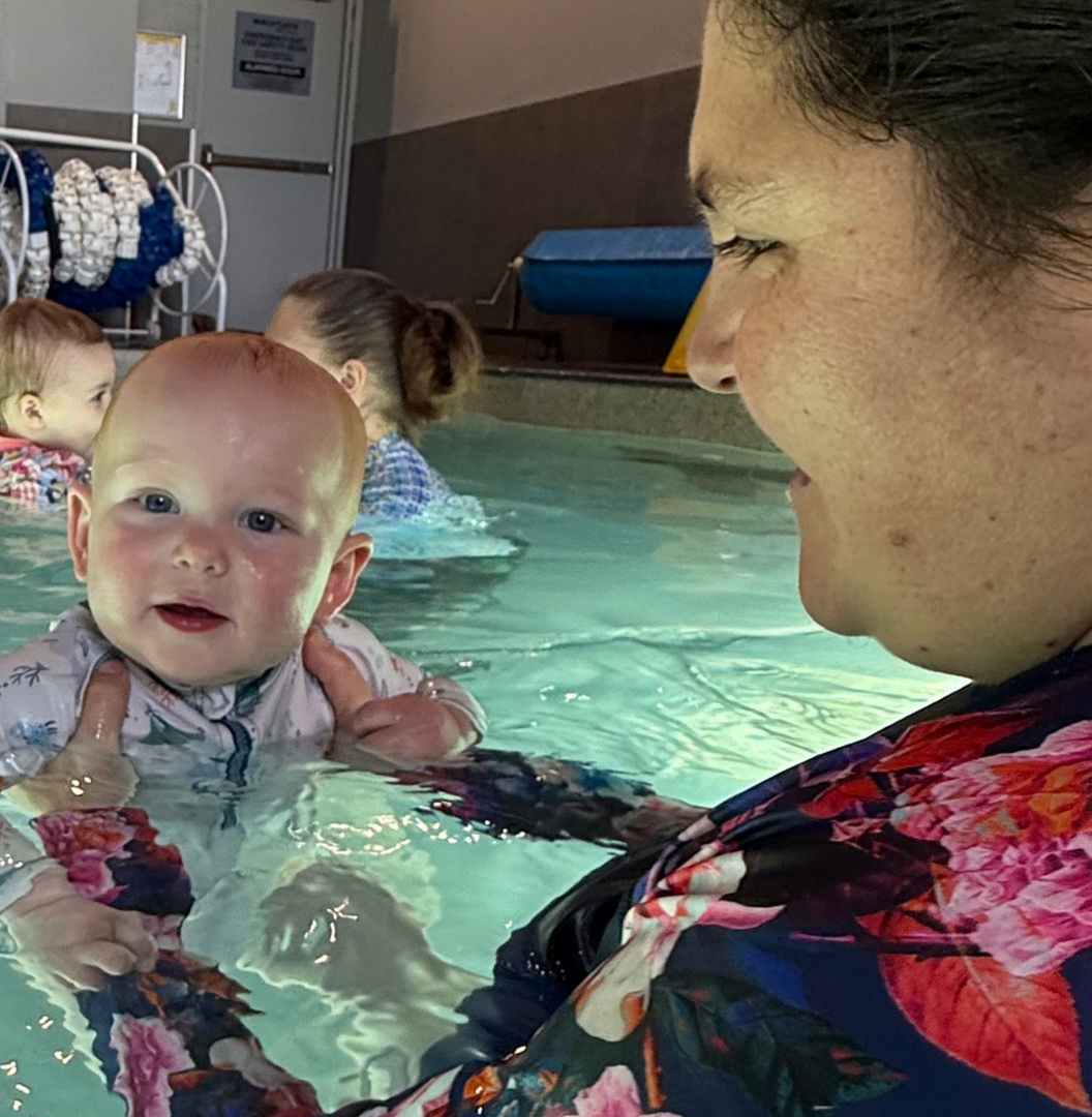 Woman Holding Baby in a Swimming Pool — DNA Aquatics in Bundaberg, QLD