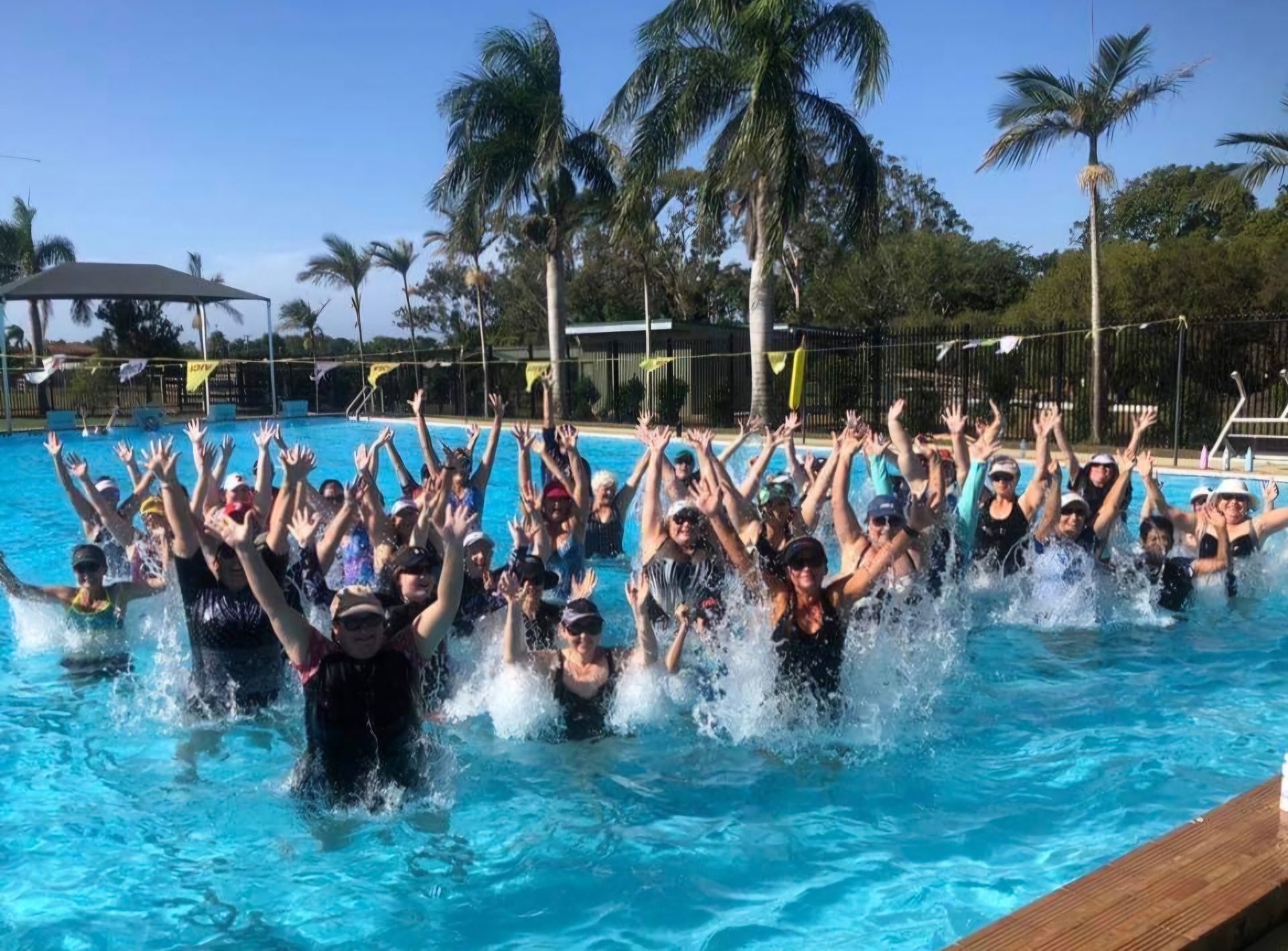 A group of people are swimming in a swimming pool. — DNA Aquatics in Bundaberg, QLD