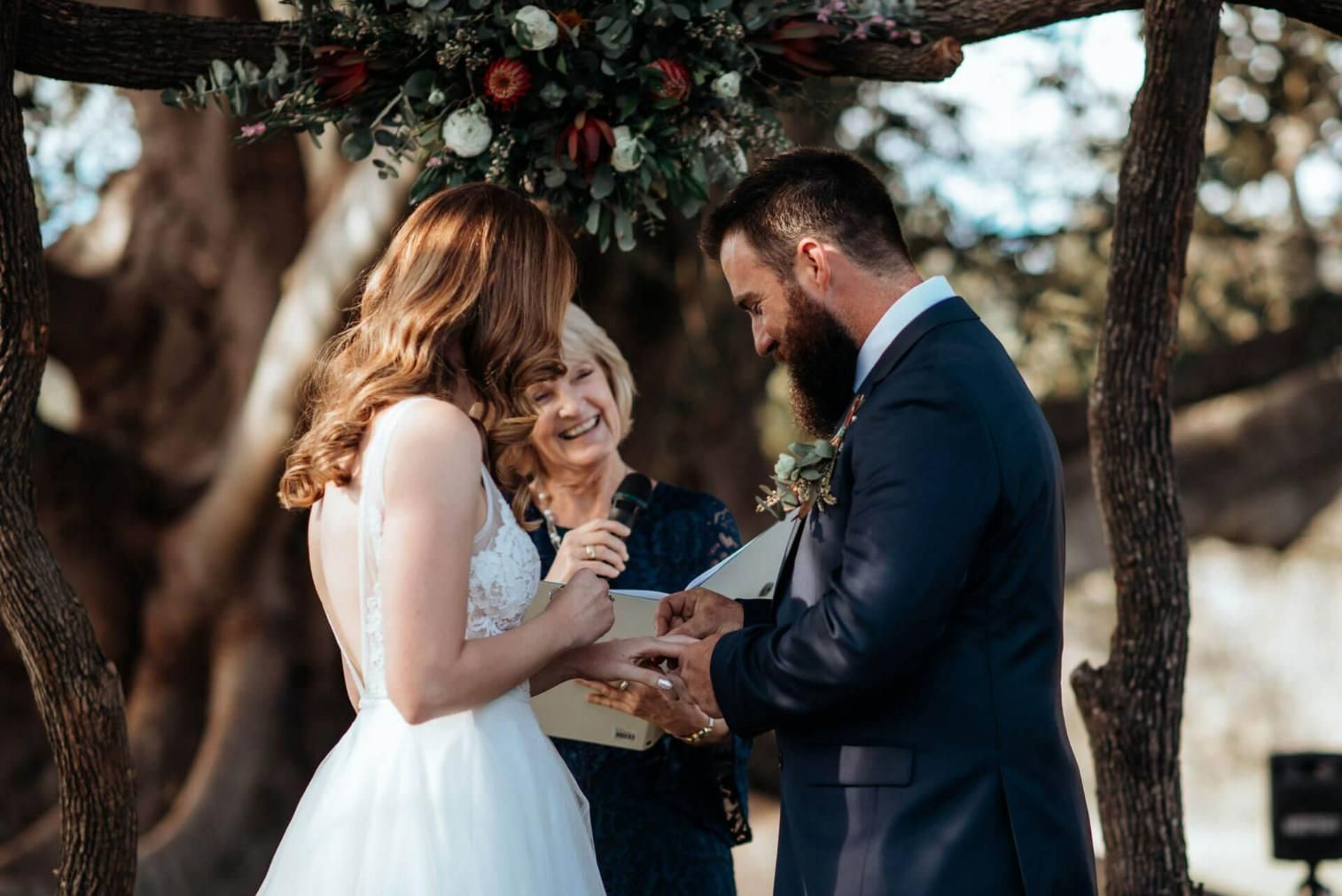 A Bride and Groom Are Holding Hands On Their Wedding — Vivienne Celebrant - Gold Coast Wedding Celebrant in Mudgeeraba, QLD