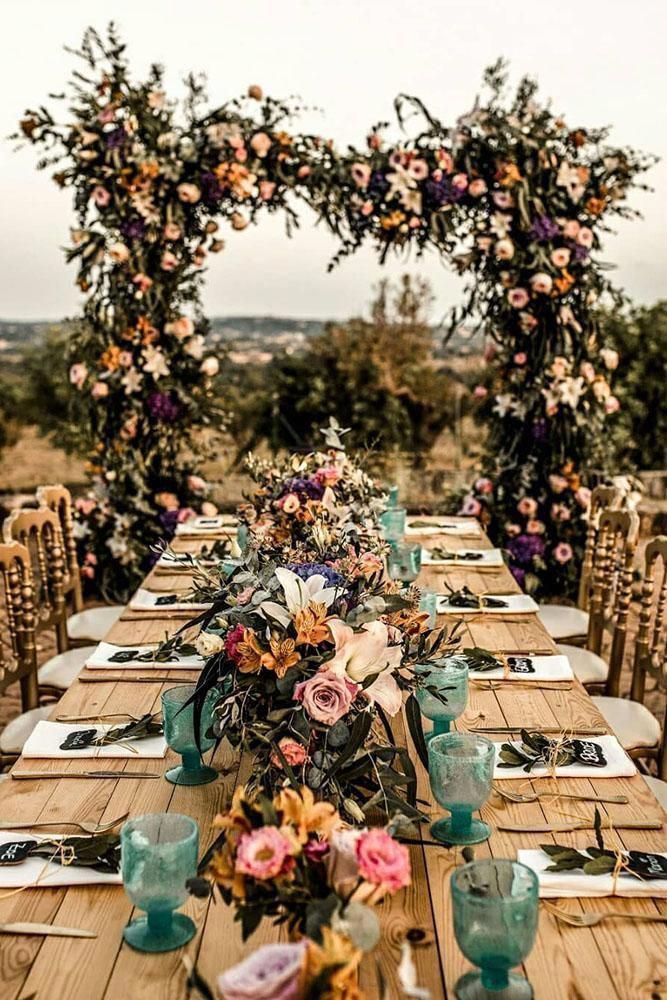 A Long Wooden Table with A Floral Arch — Vivienne Celebrant - Gold Coast Wedding Celebrant in Mudgeeraba, QLD