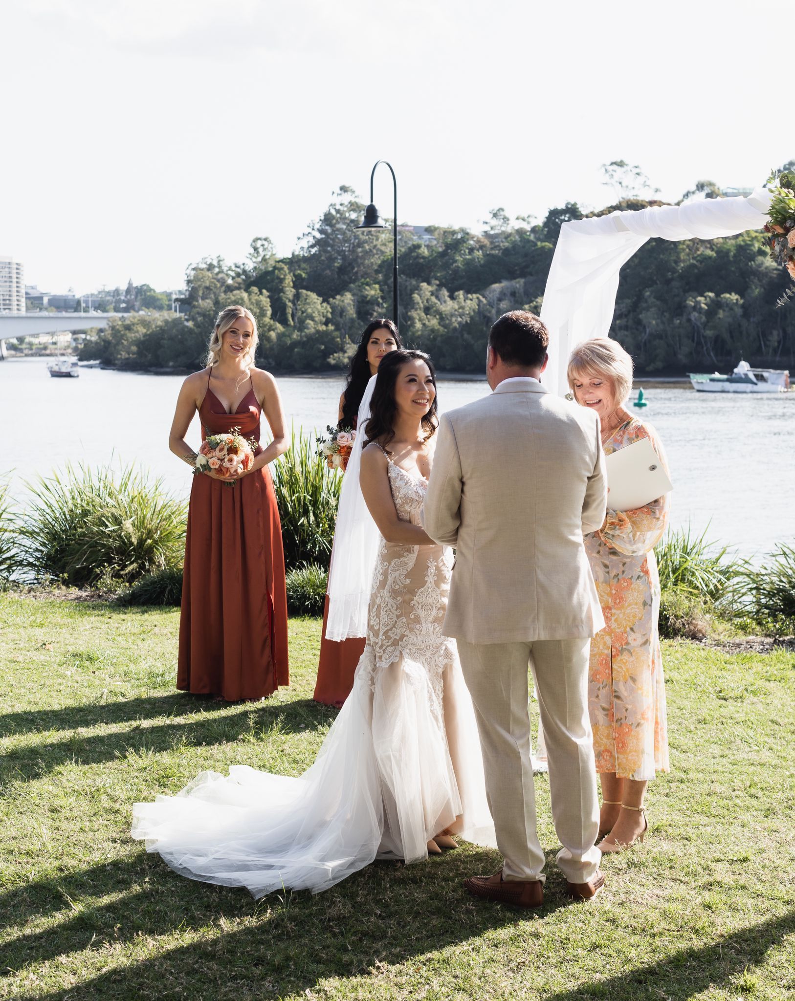 A Woman Is Holding a Microphone in Front of A Gazebo — Vivienne Celebrant - Gold Coast Wedding Celebrant in Mudgeeraba, QLD