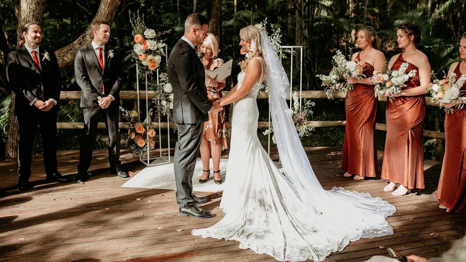 A Bride and Groom Are Holding Hands On Their Wedding — Vivienne Celebrant - Gold Coast Wedding Celebrant in Mudgeeraba, QLD