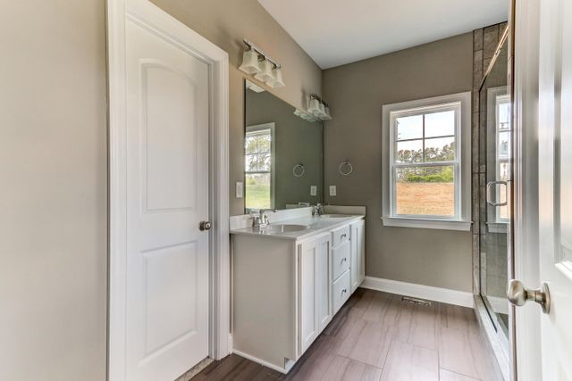 Bathroom With White Door — Greensboro, NC — Sparks Homes & Home Renovations Inc