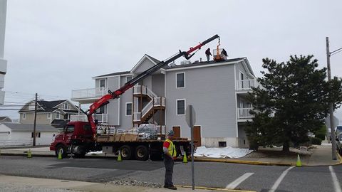 Repairs — Professional Workers Working On Roof with Crane On Truck in Ocean City, NJ