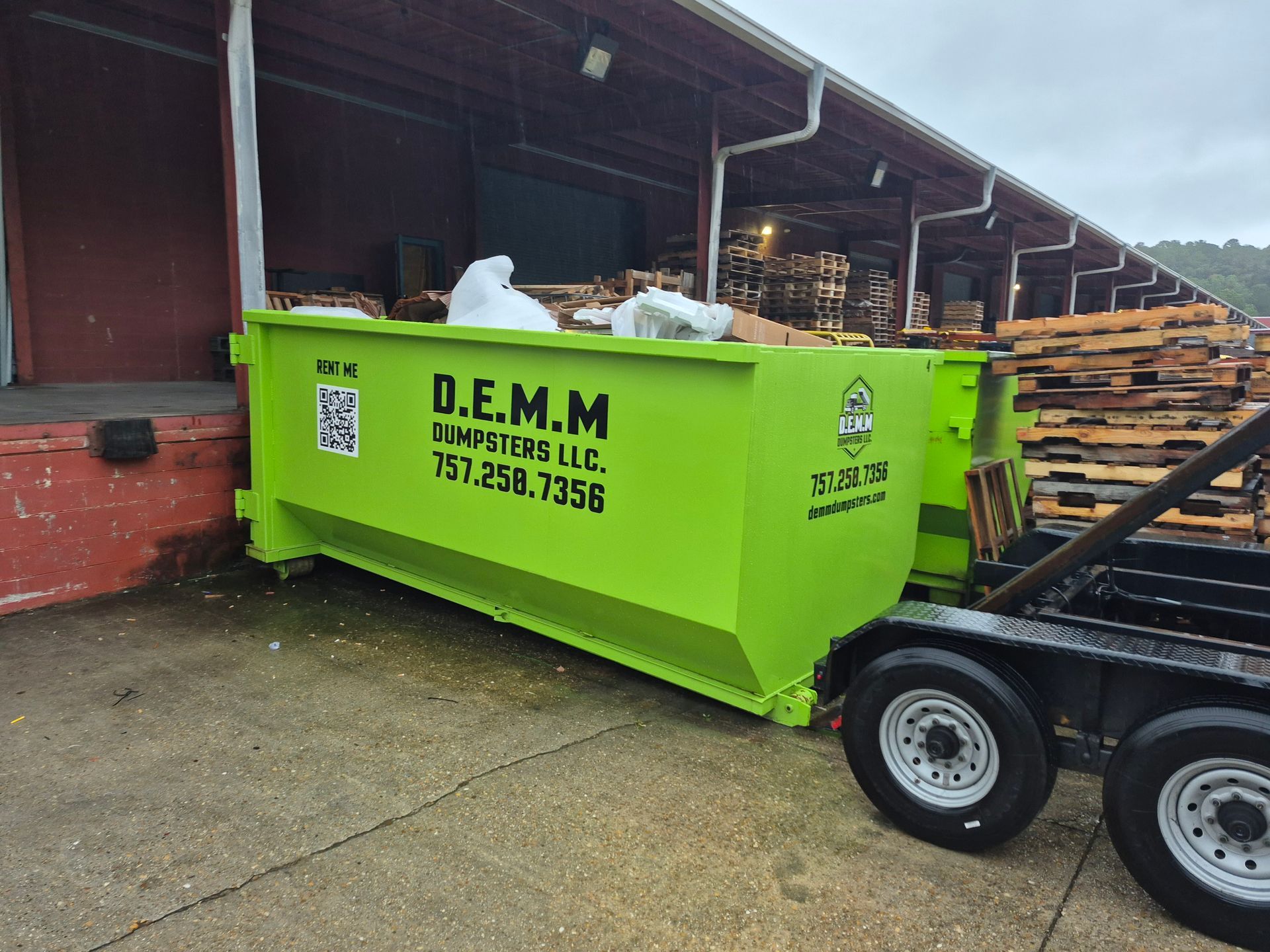 Bright green roll-off dumpster delivered for a Portsmouth VA project by D.E.M.M. Dumpsters