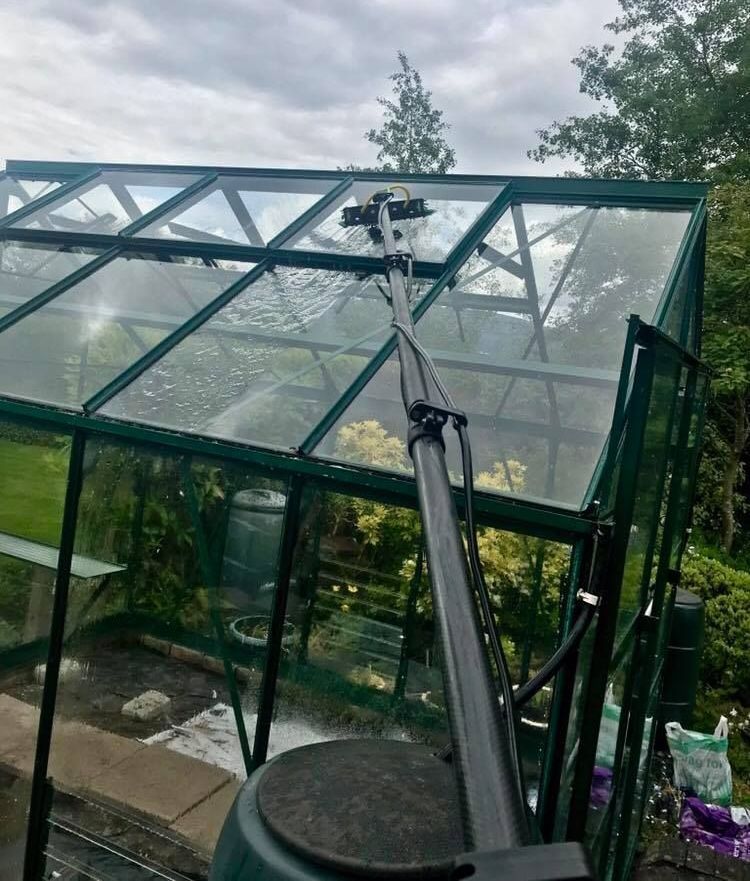 A greenhouse with a sprinkler on top of it