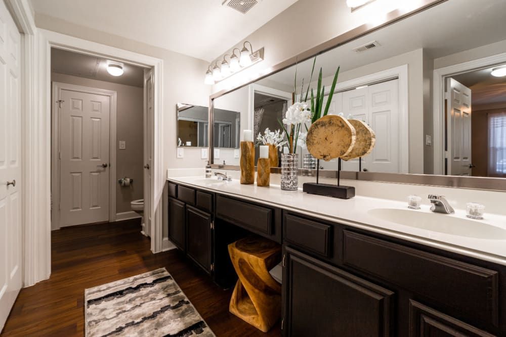 a bathroom with two sinks and a large mirror at Marquis at Great Hills in Austin, TX.
