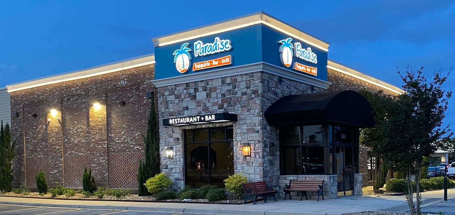 A large brick building with a blue sign on top of it.