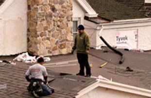 Two man installing Roof— Roofing Services in Dr. Santa Maria, CA