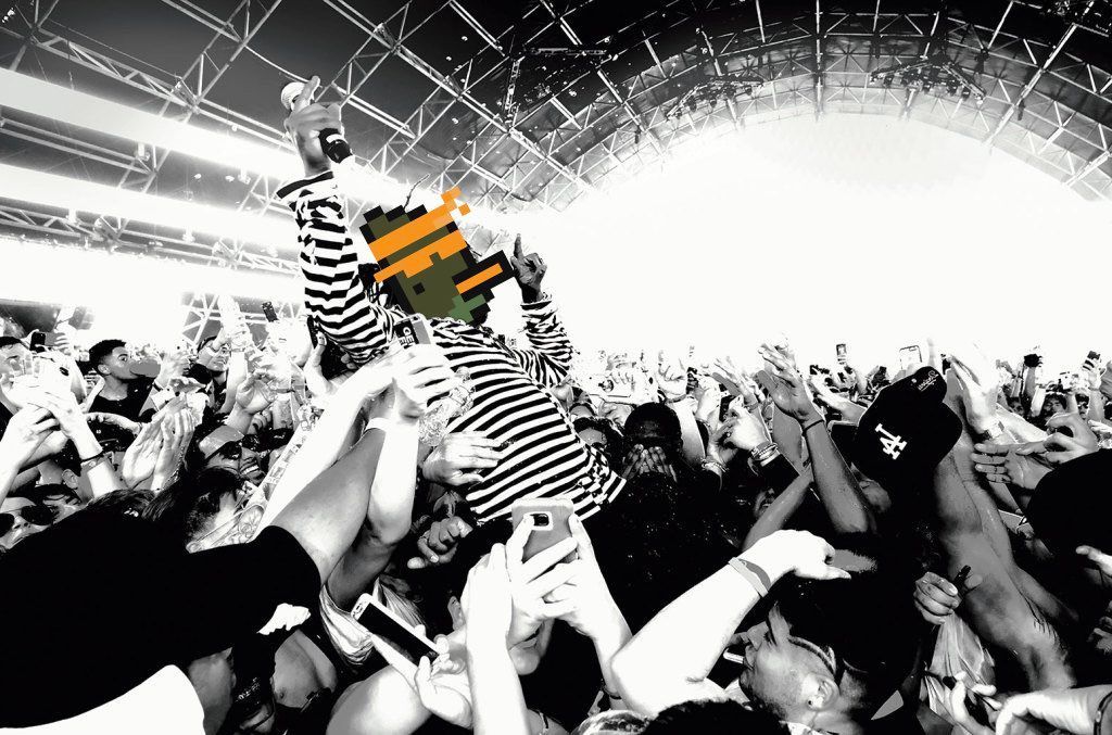 A black and white photo of a crowd of people at a concert.