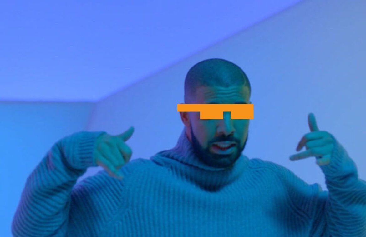 A man wearing a blue sweater and sunglasses is pointing at the camera.
