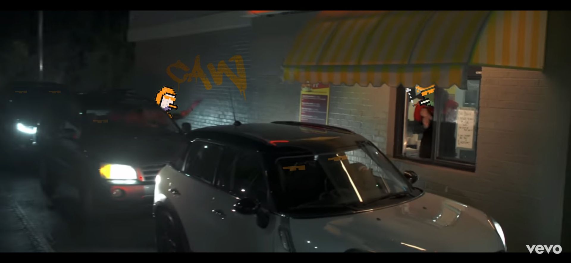 A car is parked in front of a fast food restaurant.