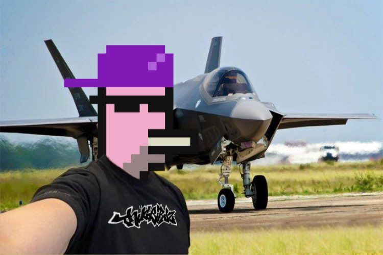 A man taking a selfie in front of a fighter jet