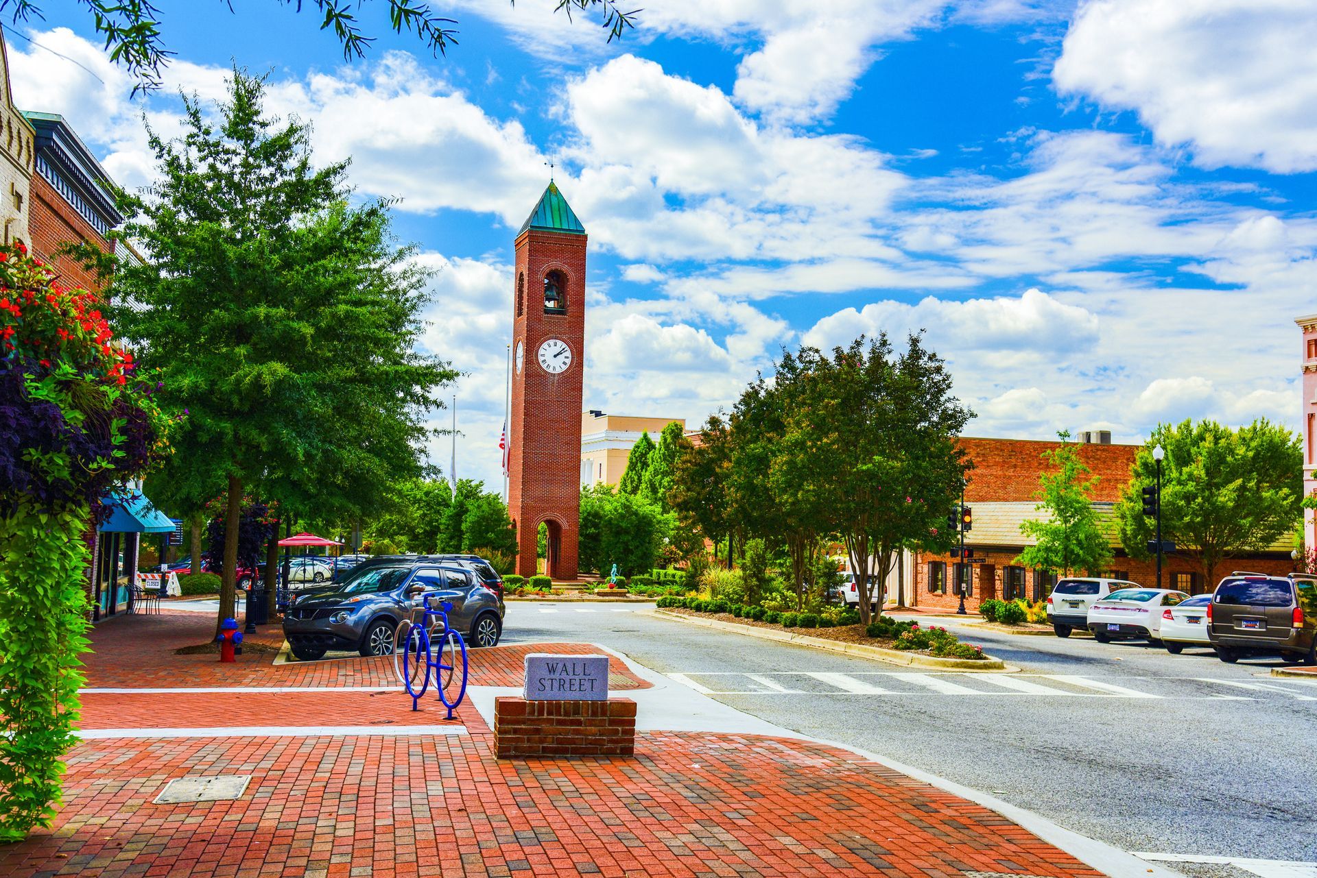 There is a clock tower in the middle of the street .