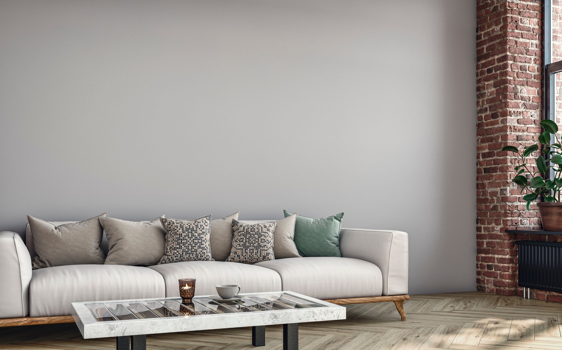 A living room with a couch , coffee table , and brick wall .