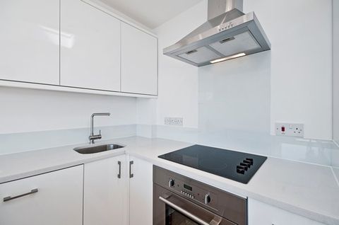 modern white kitchen with a range hood