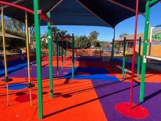 Playground with rubber flooring, climbing structures, and shade covering — Dubbo Premier Landscapes in Dubbo, NSW