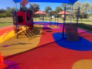 Colorful playground with slides, stairs, and climbing bars on a sunny day — Dubbo Premier Landscapes in Dubbo, NSW