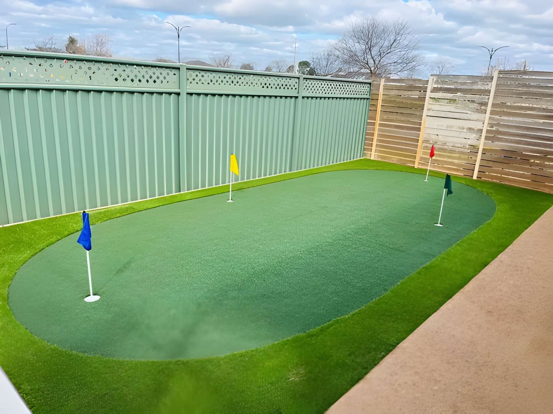 Artificial Turf Putting Green With Four Flags, Fenced in — Dubbo Premier Landscapes in Dubbo, NSW