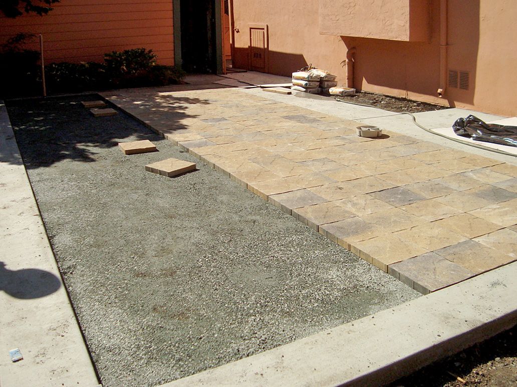 A patio is being built in front of a house