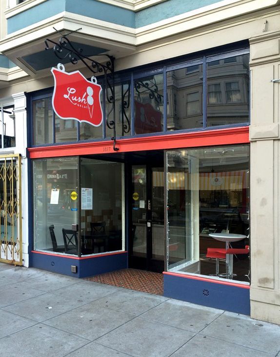 A store front with a red sign that says ' louis ' on it