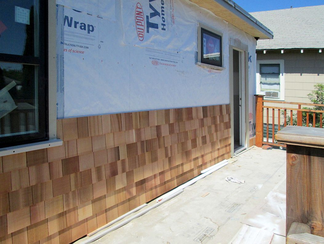 The side of a house is covered in styrofoam wrap
