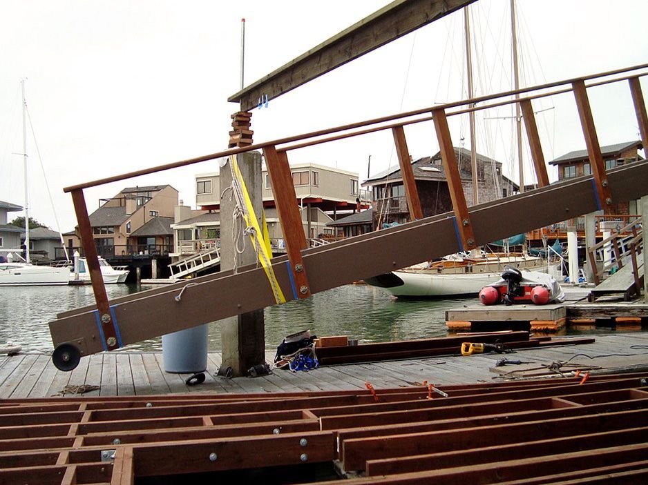 A wooden bridge is being built over a body of water