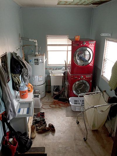 A laundry room with a washer and dryer stacked on top of each other.