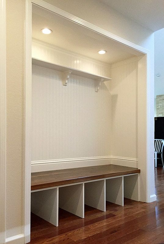 There is a bench in the corner of the room.