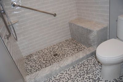 A bathroom with a walk in shower and a toilet.