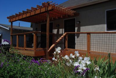 A house with a wooden deck and a pergola
