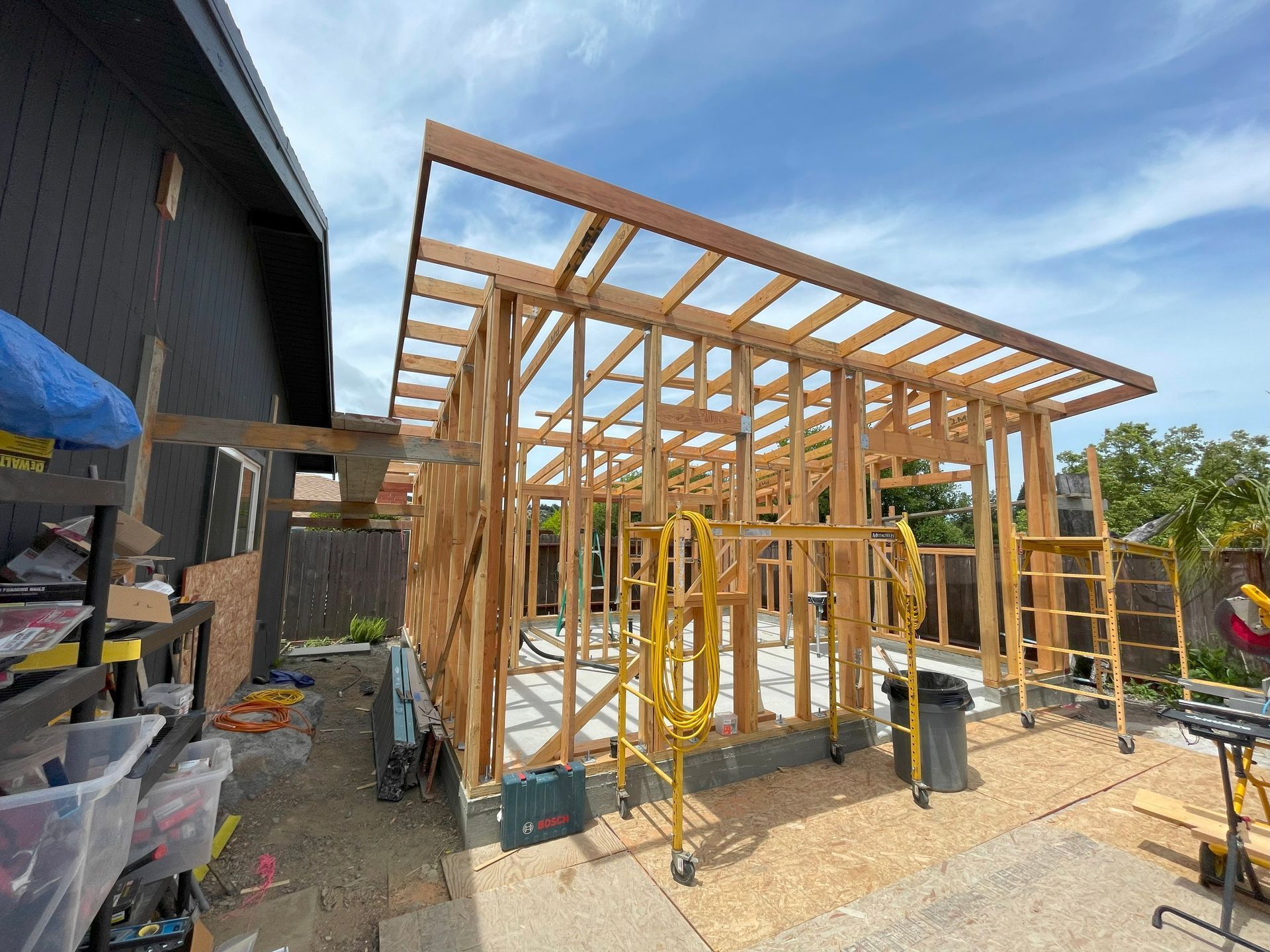 A concrete floor is being built in front of a house.