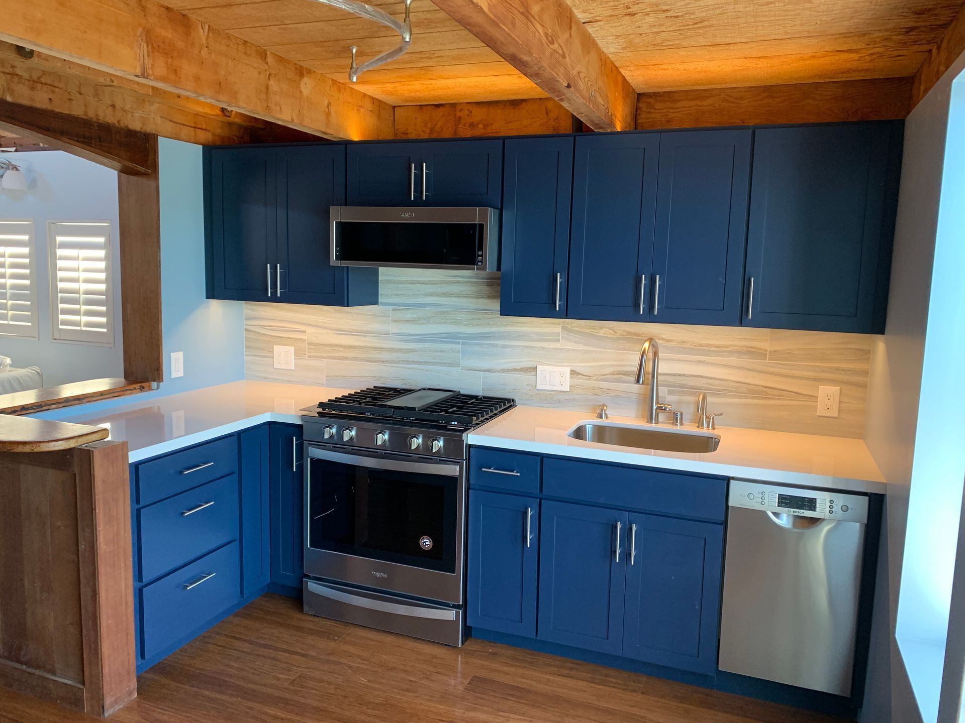A kitchen with white cabinets and stainless steel appliances