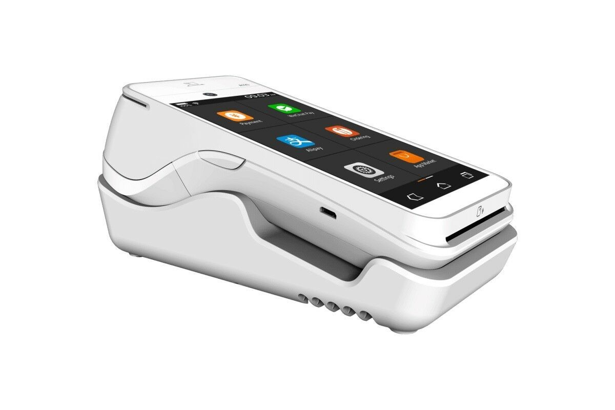 A white phone is sitting on top of a white dock.