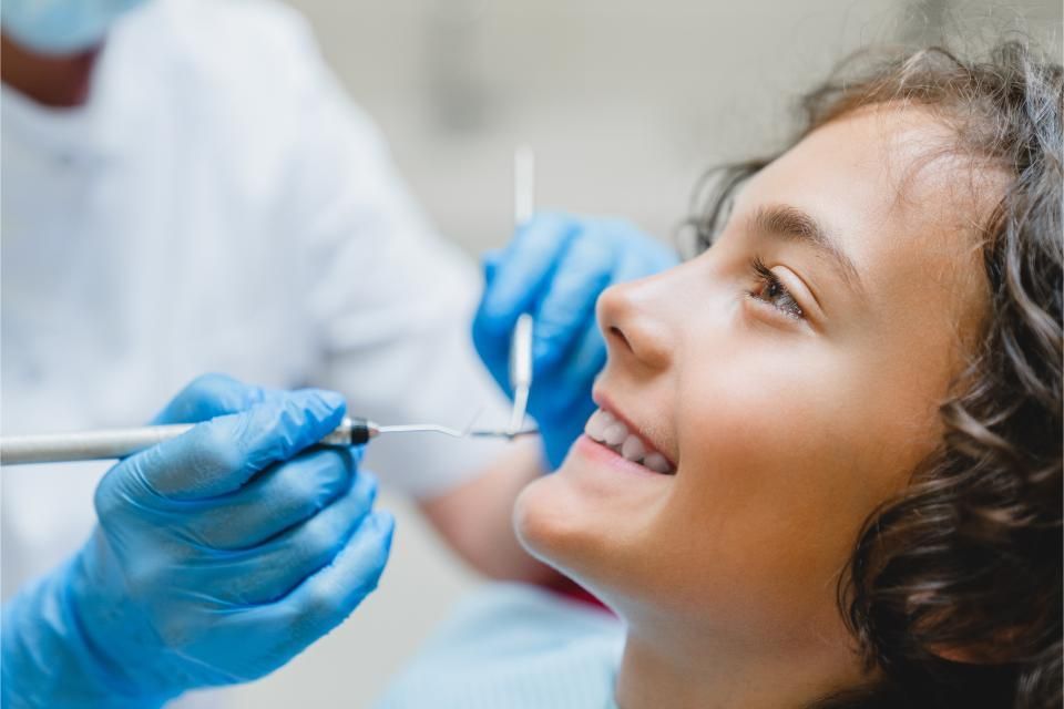 A young boy is getting his teeth examined by an Oral Hygienist in Pretoria East.