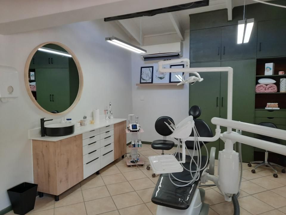 Megan Carvill's oral hygiene office in Erasmusrand, Pretoria with a dental chair, sink and mirror.
