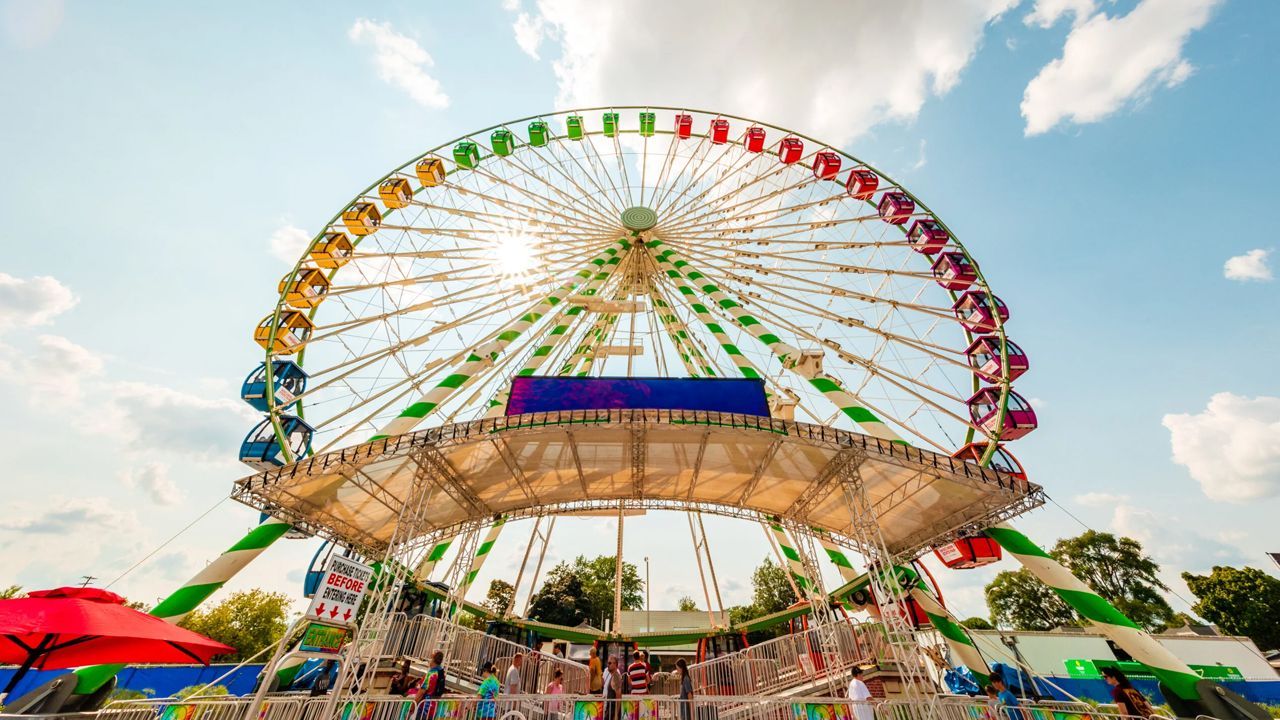 People enjoying a festival in Wisconsin with food stalls, live music, and decorations