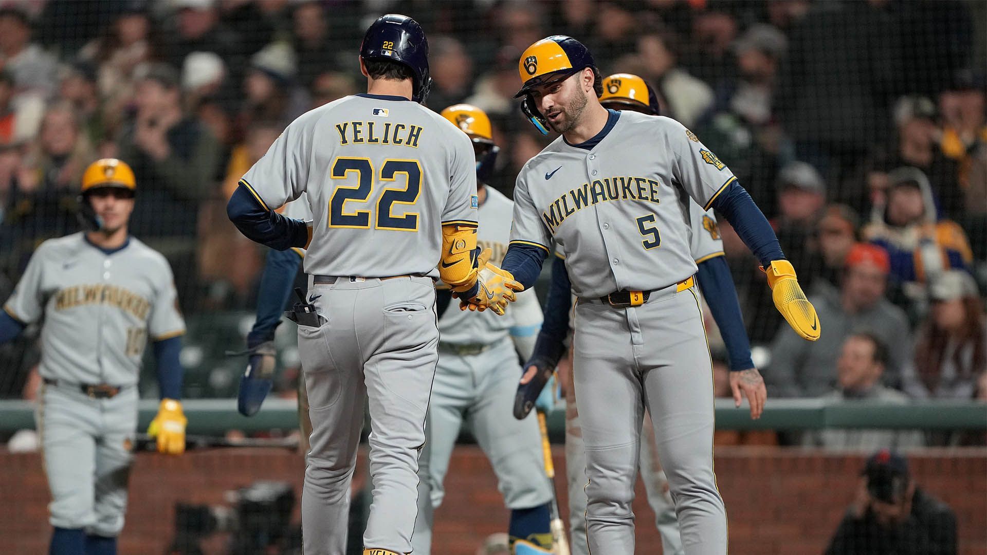 Catch an exciting Milwaukee Brewers baseball game this summer at American Family Field. Milwaukee Brewers baseball players celebrating a run during a summer game.