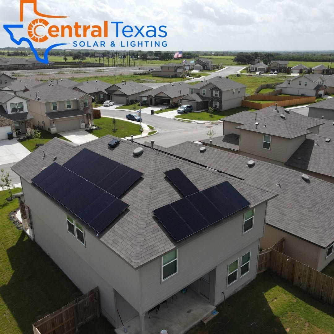 Aerial view of a suburban home with rooftop solar panels in a neighborhood