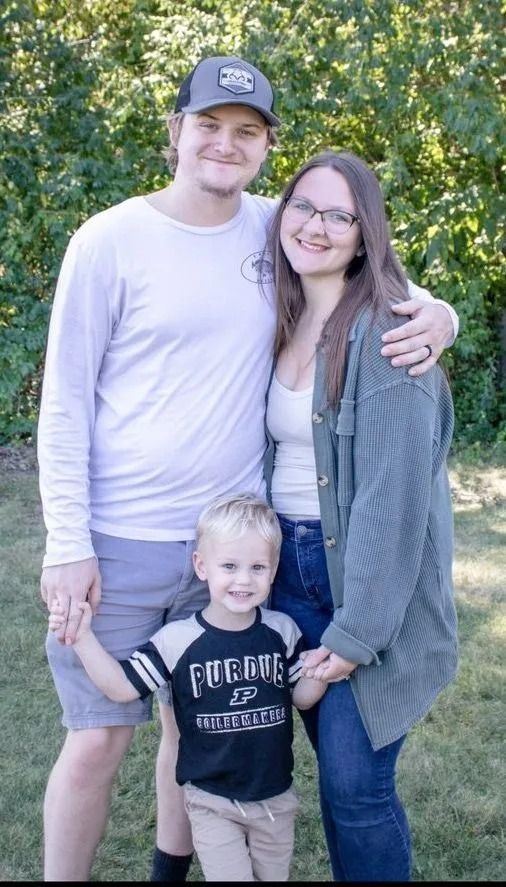 A man , woman and child are posing for a picture.