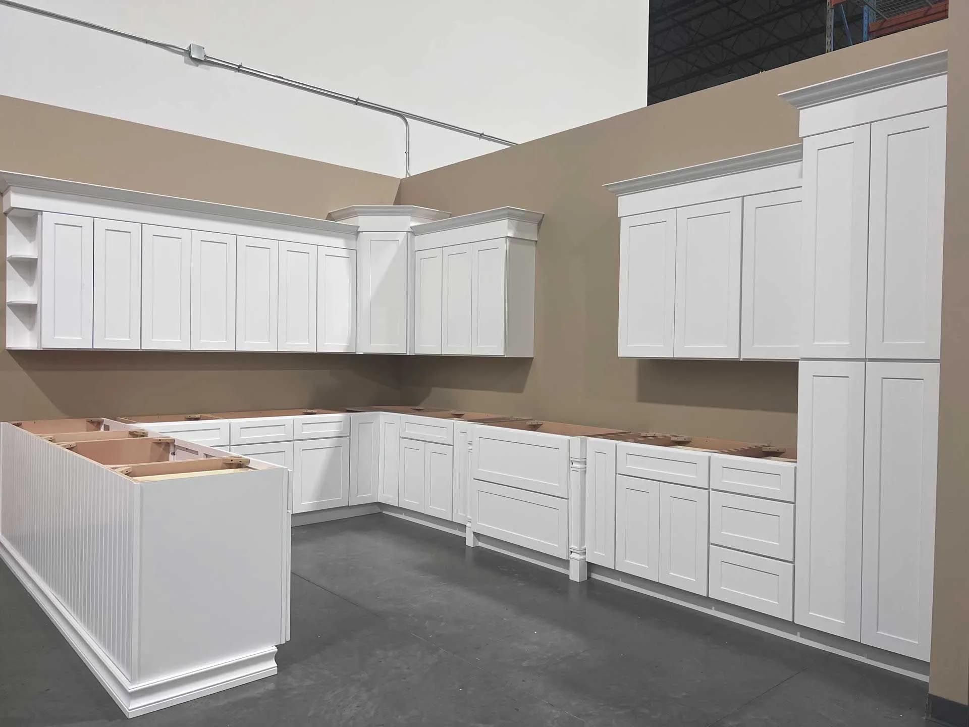 A kitchen with white cabinets and a large island